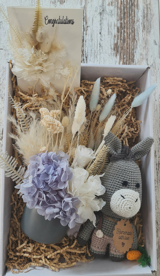 Baby gift  box with dried flowers and  handcrafted crochet toy donkey. 